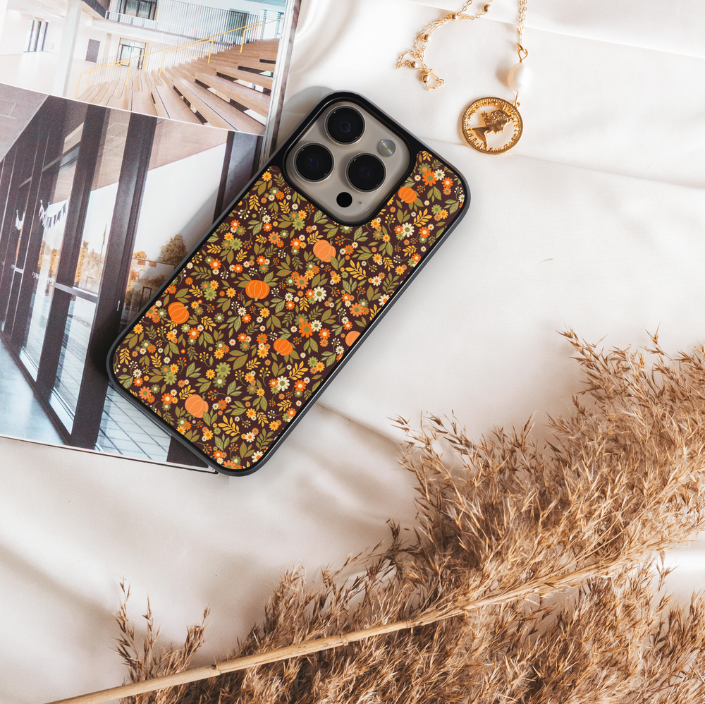 iPhone case with chic pumpkin and floral pattern in warm autumn tones – girly fall aesthetic design.