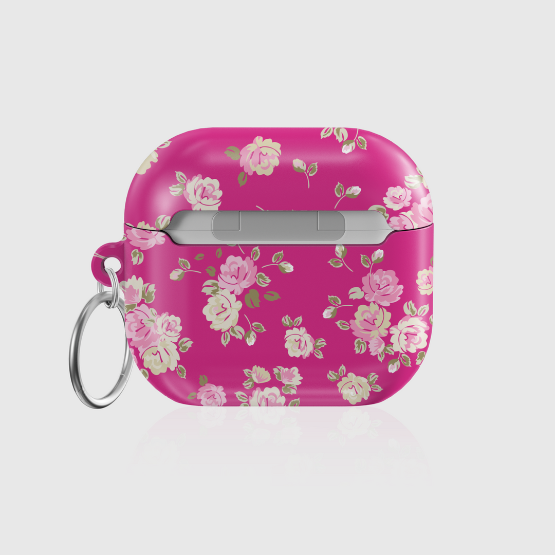 Pink AirPods case featuring vintage rose pattern and keychain ring, glossy finish—stylish and protective accessory for music lovers.