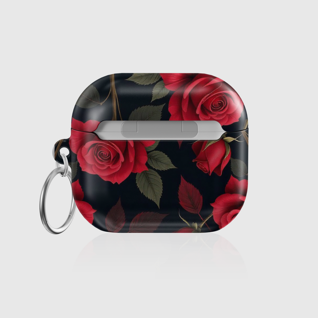Glossy AirPods case with deep red rose floral design on a black background, featuring a silver keychain—romantic and elegant accessory for music lovers.