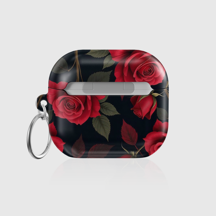 Glossy AirPods case with deep red rose floral design on a black background, featuring a silver keychain—romantic and elegant accessory for music lovers.