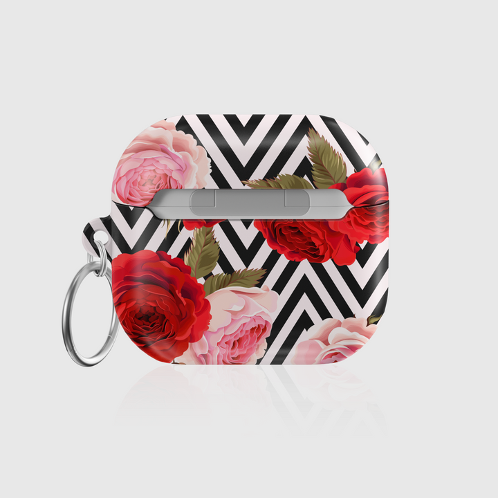 Stylish AirPods case featuring a bold black-and-white chevron pattern with red and pink roses, complete with keychain—chic and protective accessory for music lovers.