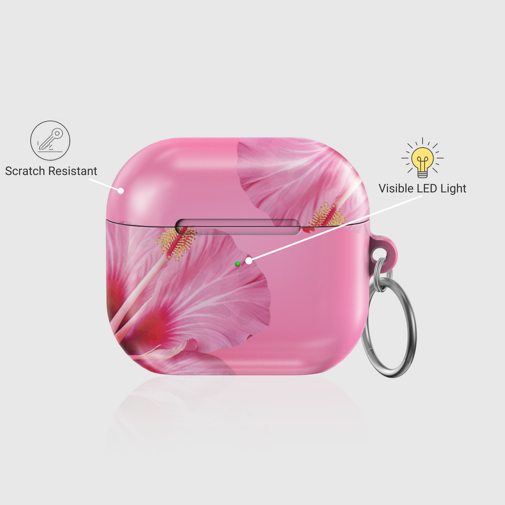 Pink AirPods case with large hibiscus flower print, tropical floral design, and silver keychain—stylish and protective earbud cover for a summery music vibe.