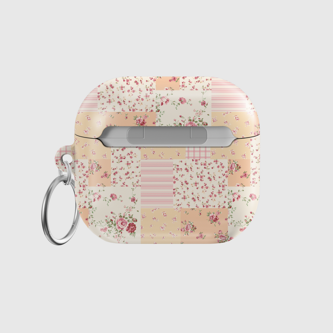 AirPods case featuring a vintage patchwork design with pastel floral patterns, soft pink and beige tones, and a silver keychain—charming and protective earbuds cover with a cottagecore aesthetic.