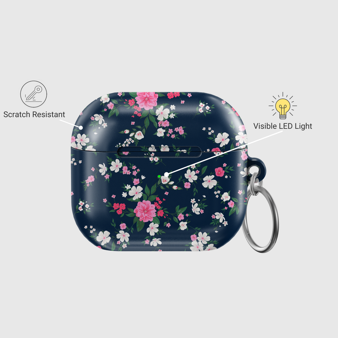 Glossy navy AirPods case with pink and white floral pattern and green leaves, designed with a silver keychain—chic and protective cover for music lovers.