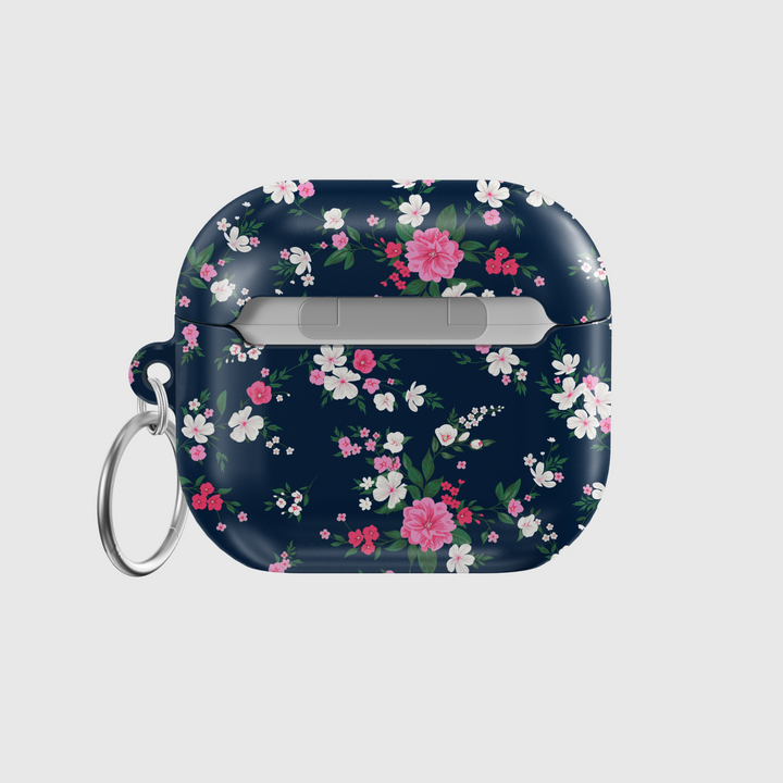 Glossy navy AirPods case with pink and white floral pattern and green leaves, designed with a silver keychain—chic and protective cover for music lovers.