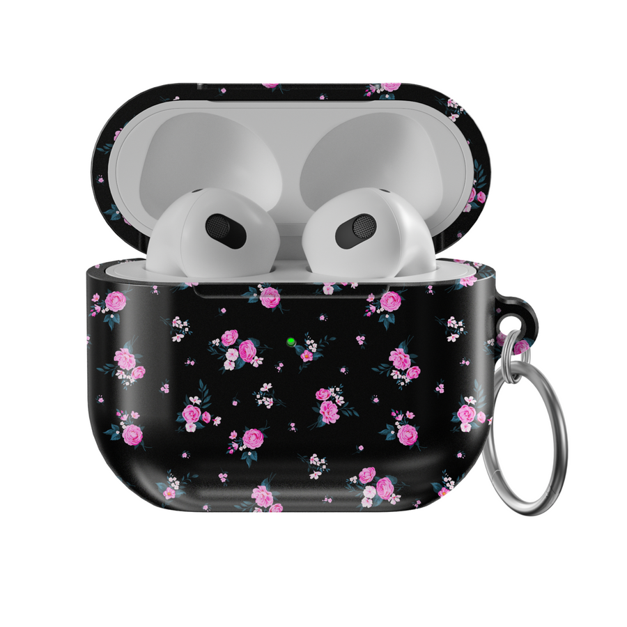 Glossy black AirPods case featuring scattered pink rose floral pattern with mini white accents, paired with a silver keychain—stylish and protective for music lovers on the go.