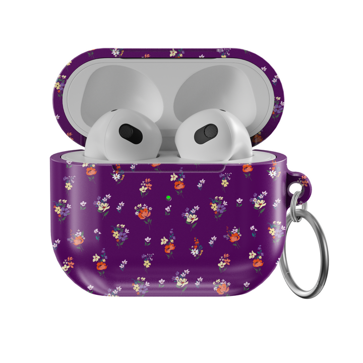 Glossy purple AirPods case with delicate mini floral bouquet pattern in red, orange, yellow, and white, complete with a silver keychain—perfect for a music lover with a soft spot for bold floral style.