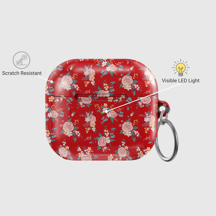 Glossy red AirPods case featuring delicate vintage-style floral print with soft pink roses and blue leaves, paired with a silver keychain—ideal for romantic, music-loving aesthetics.