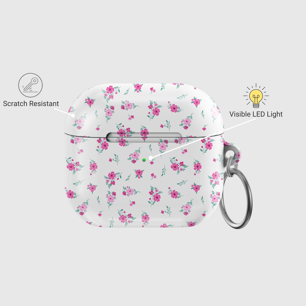White AirPods case with tiny pink floral pattern and silver keychain, featuring a glossy finish—perfect for music lovers and feminine aesthetics.