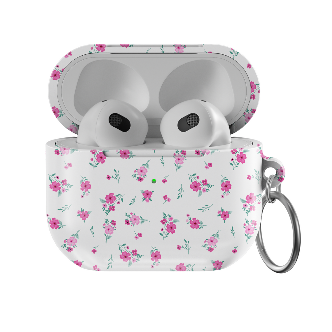White AirPods case with tiny pink floral pattern and silver keychain, featuring a glossy finish—perfect for music lovers and feminine aesthetics.