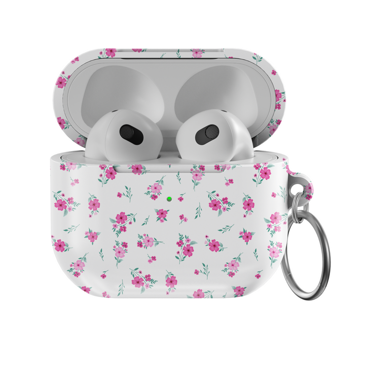 White AirPods case with tiny pink floral pattern and silver keychain, featuring a glossy finish—perfect for music lovers and feminine aesthetics.