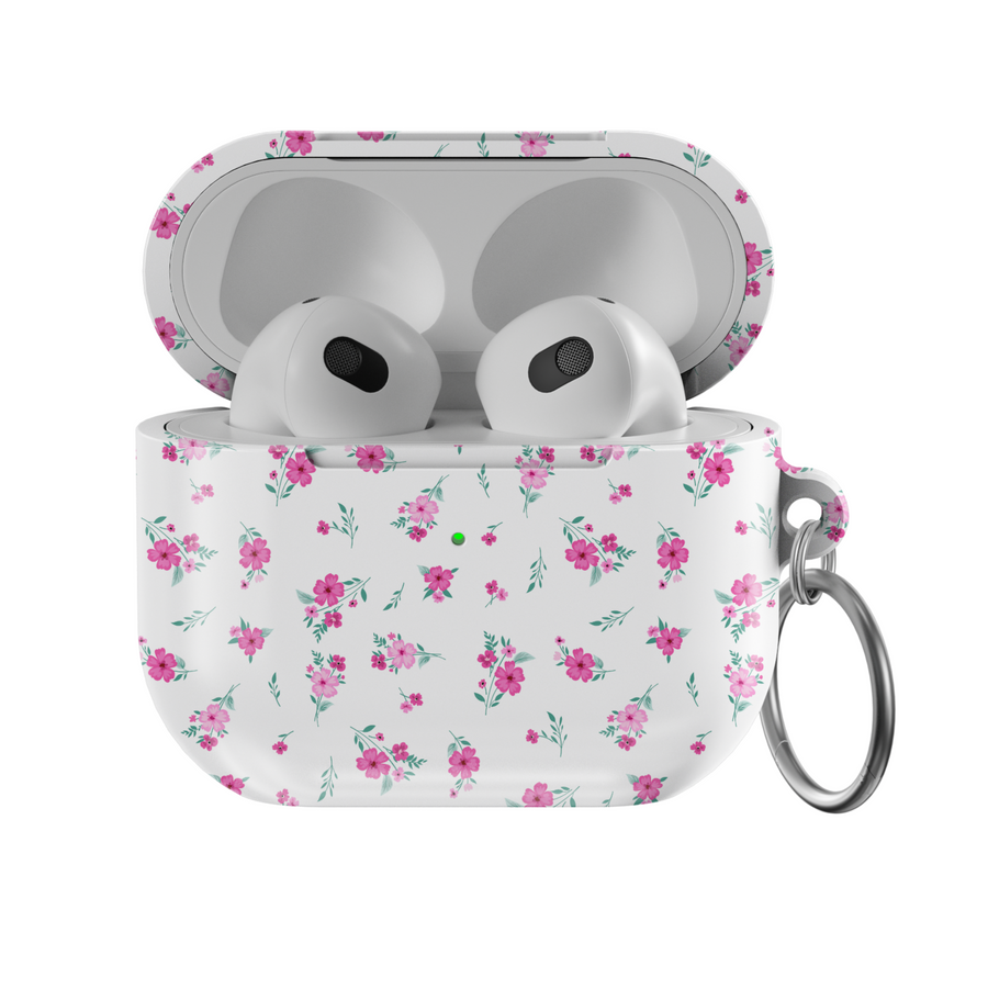 White AirPods case with tiny pink floral pattern and silver keychain, featuring a glossy finish—perfect for music lovers and feminine aesthetics.