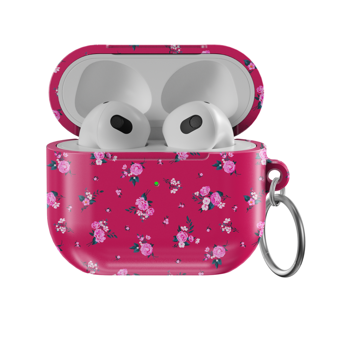 Glossy AirPods case in vibrant pink featuring scattered rose floral pattern and attached silver keychain, designed for music lovers who enjoy romantic and feminine styles.