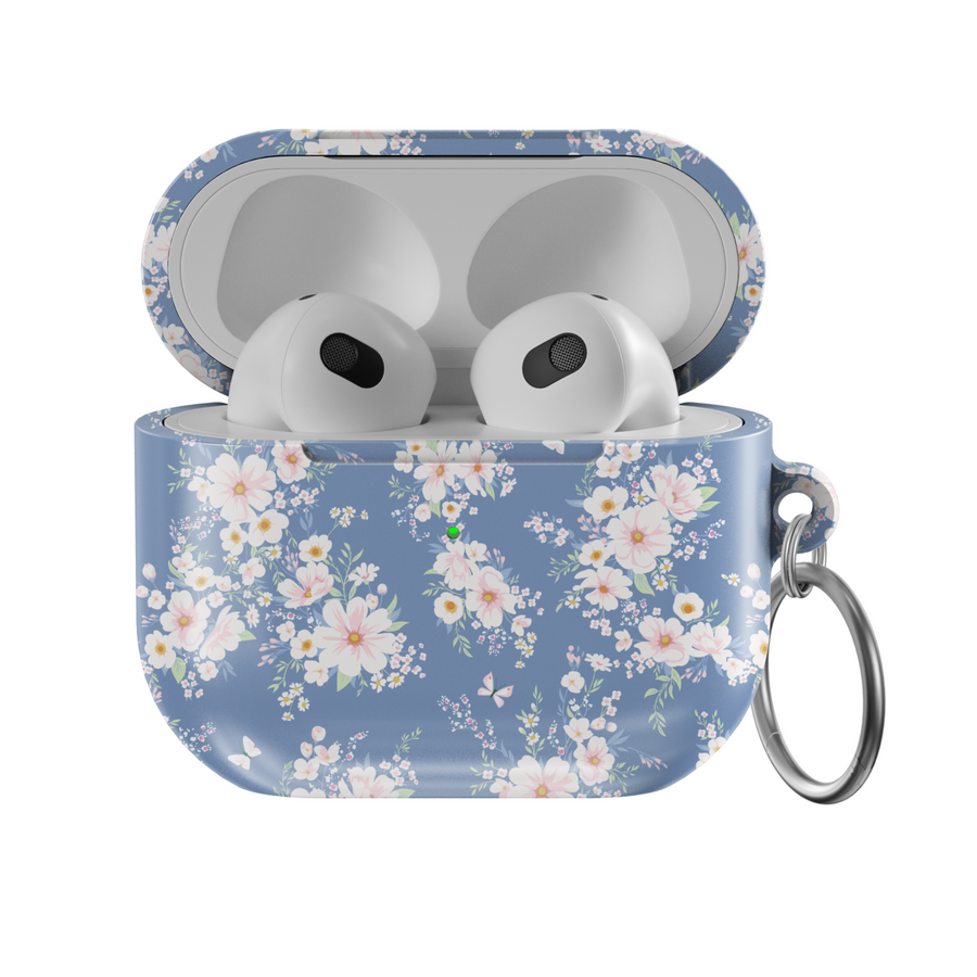 AirPods case with a soft blue background and delicate white and blush floral pattern, featuring a glossy finish and silver keychain, designed for music lovers who adore a romantic and vintage aesthetic.