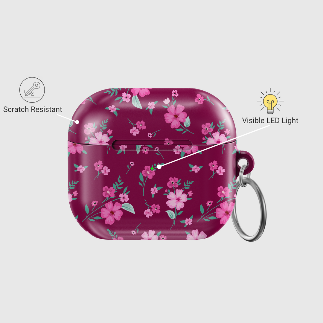 Glossy maroon AirPods case with pink floral design and keychain, perfect for music lovers looking for a stylish and protective accessory for their AirPods Pro or AirPods 3.