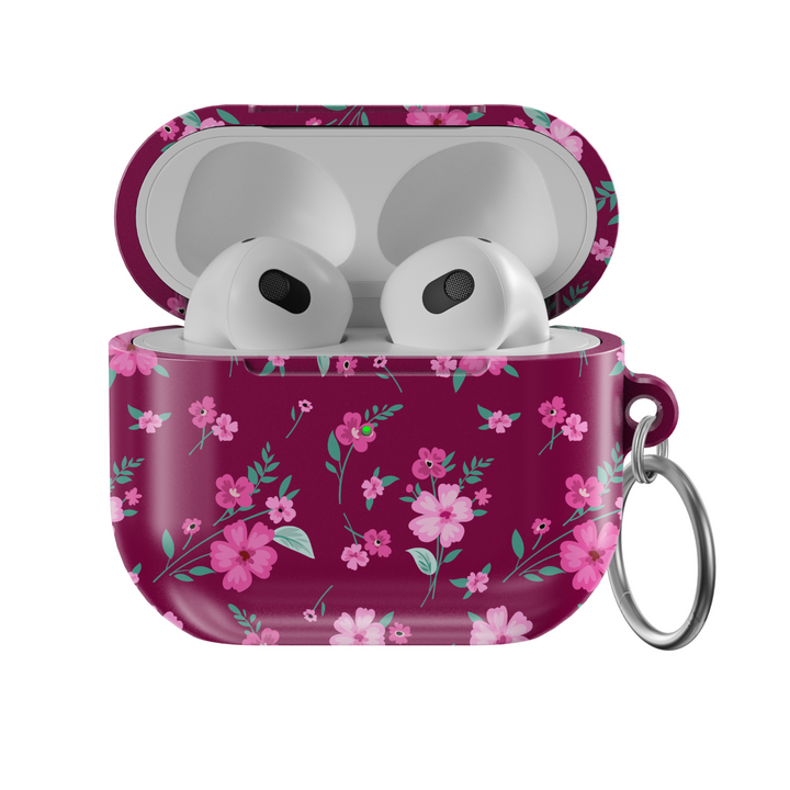 Glossy maroon AirPods case with pink floral design and keychain, perfect for music lovers looking for a stylish and protective accessory for their AirPods Pro or AirPods 3.