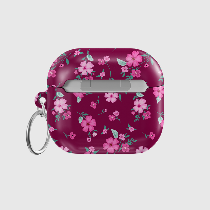 Glossy maroon AirPods case with pink floral design and keychain, perfect for music lovers looking for a stylish and protective accessory for their AirPods Pro or AirPods 3.