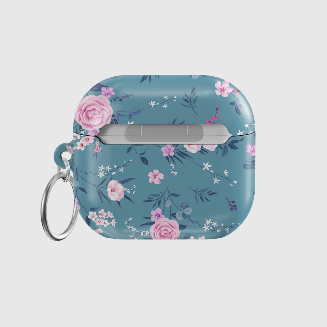 Glossy teal AirPods case with elegant pink and white floral design, featuring a secure keychain ring. A chic and music-inspired protective cover for AirPods Pro and AirPods 3.