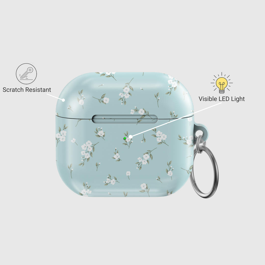 Light blue AirPods case with delicate white floral design and silver keyring, soft minimal aesthetic protective cover for AirPods Pro or AirPods 3.