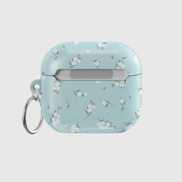 Light blue AirPods case with delicate white floral design and silver keyring, soft minimal aesthetic protective cover for AirPods Pro or AirPods 3.
