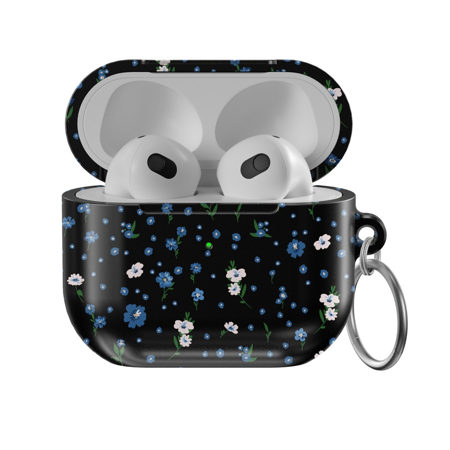 Black AirPods case with tiny blue and white floral print, silver keychain attachment, inspired by indie music vibes and soft aesthetic design for AirPods Pro or AirPods 3.
