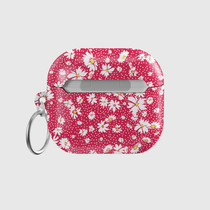 Red AirPods case with white daisy flower pattern and silver keyring, cute floral protective cover for AirPods Pro, retro spring-style accessory.