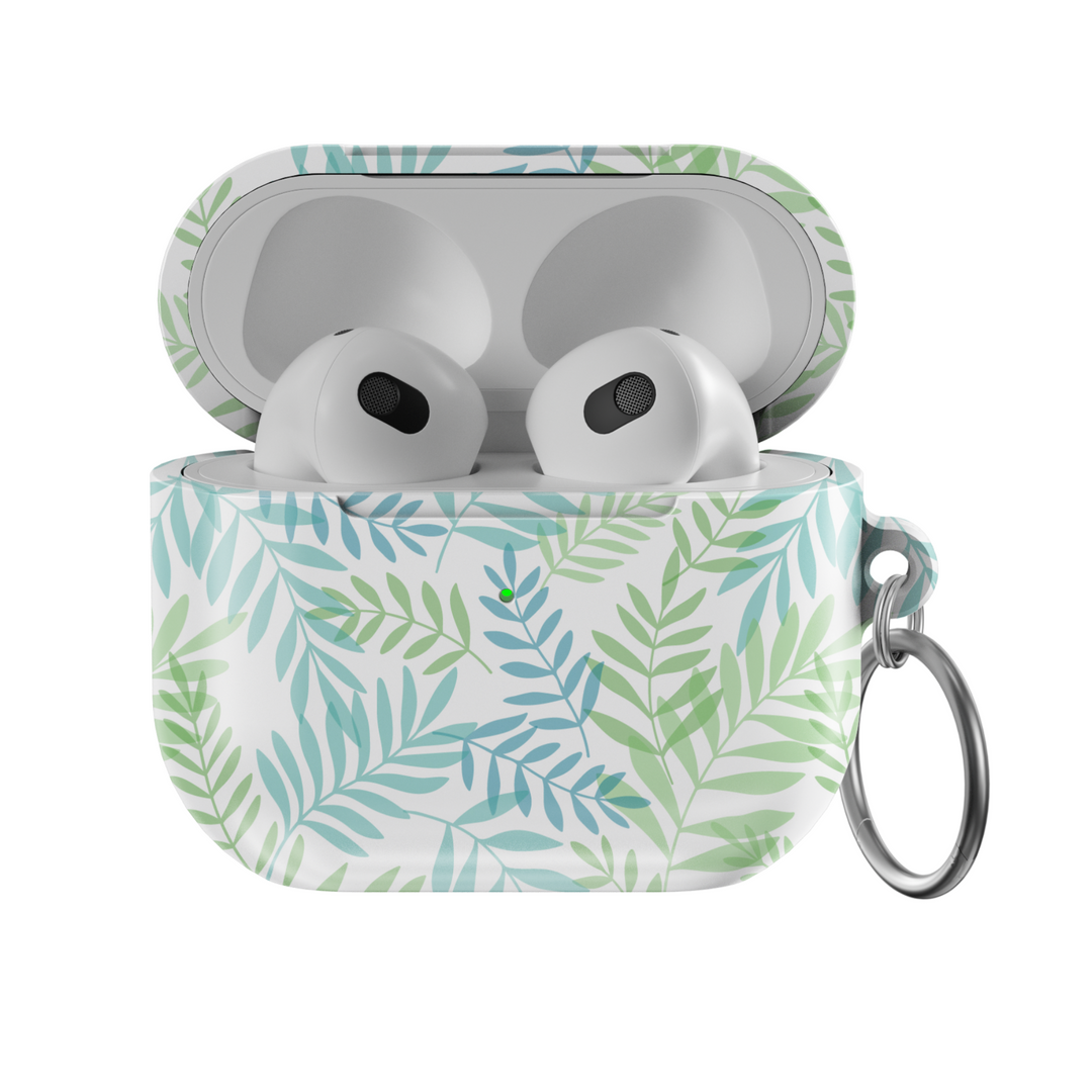 Glossy white AirPods case with green and teal botanical leaf pattern and silver keyring—tropical and nature-inspired accessory.