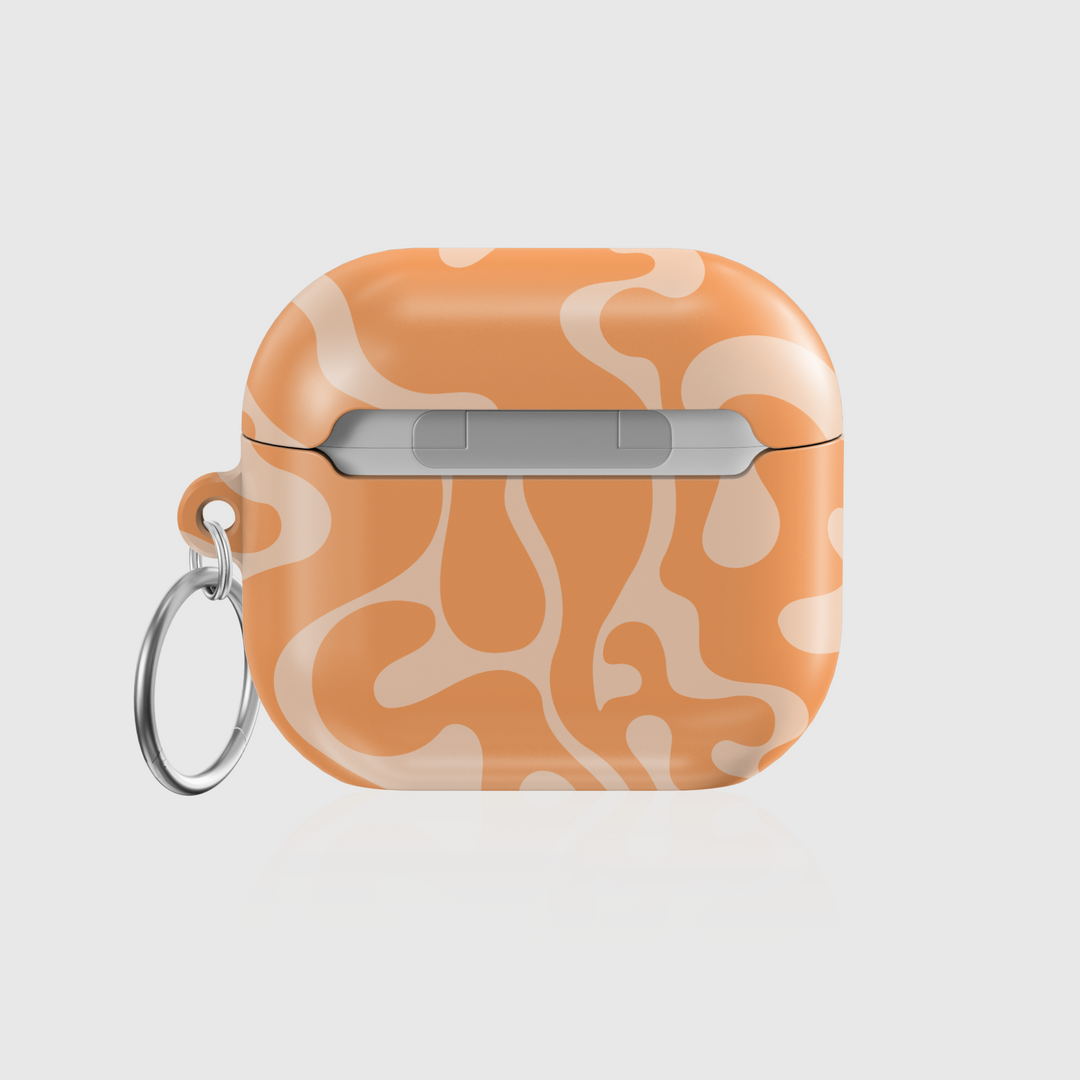 Glossy AirPods case with peach orange abstract swirl pattern and keychain ring
