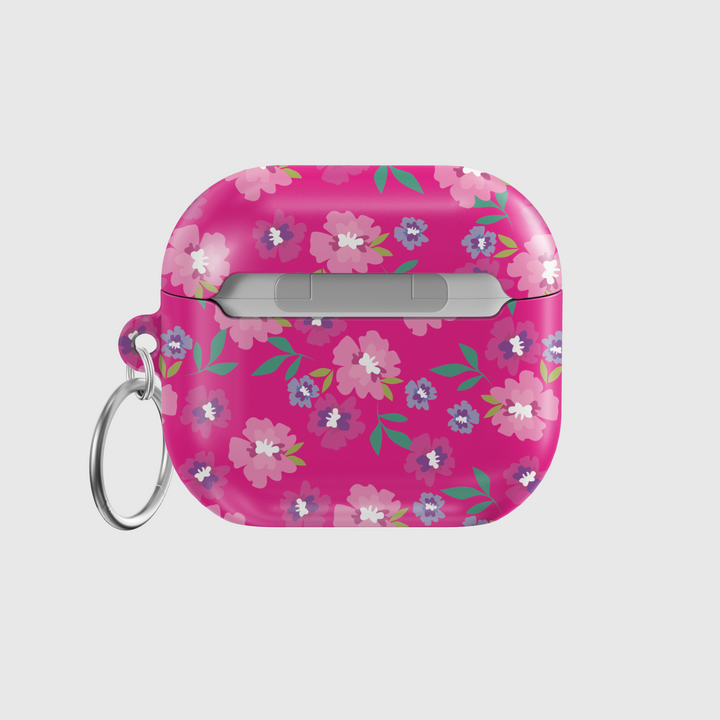 Glossy hot pink AirPods case with colorful floral print featuring white, purple, and pink flowers, includes a silver keychain ring.