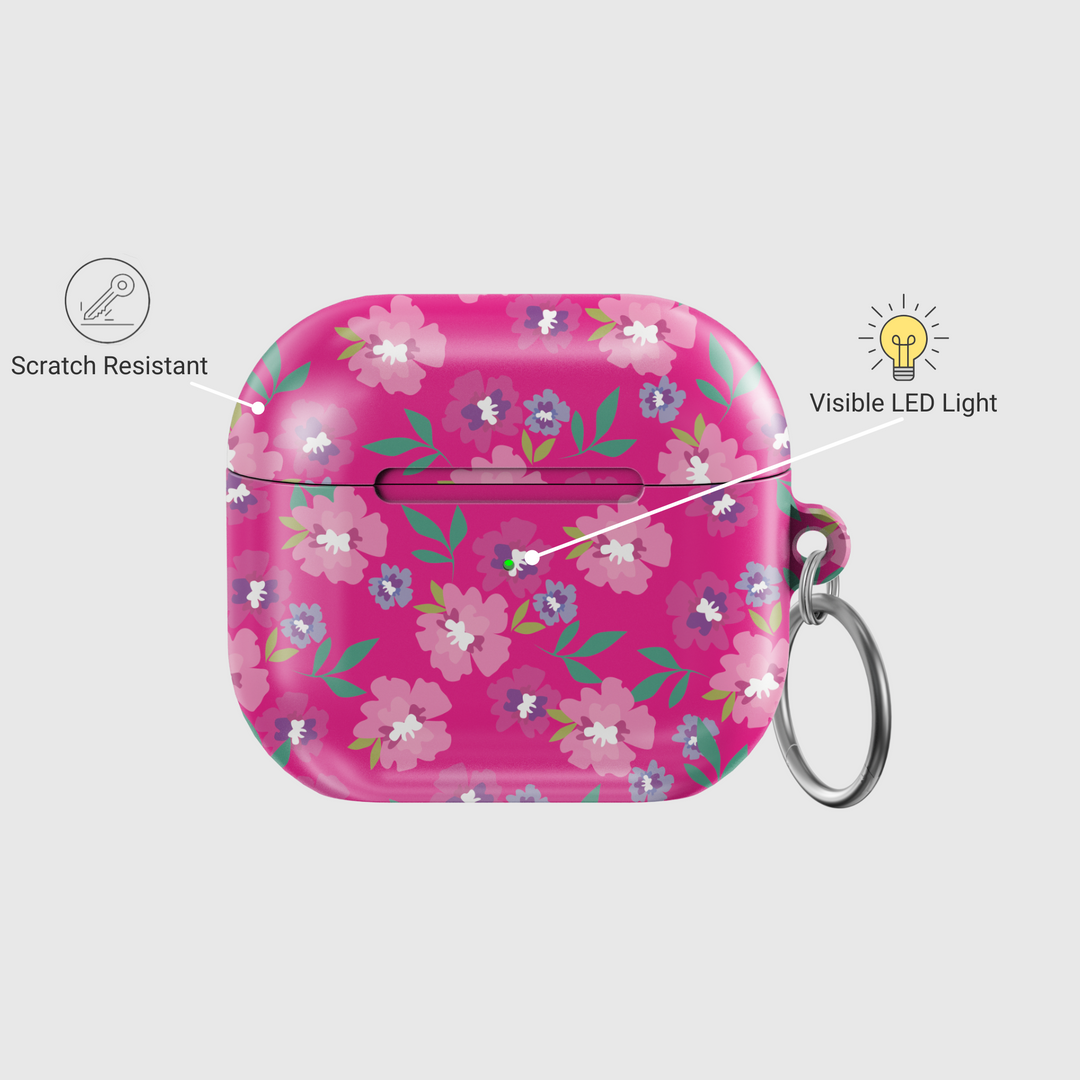 Glossy hot pink AirPods case with colorful floral print featuring white, purple, and pink flowers, includes a silver keychain ring.