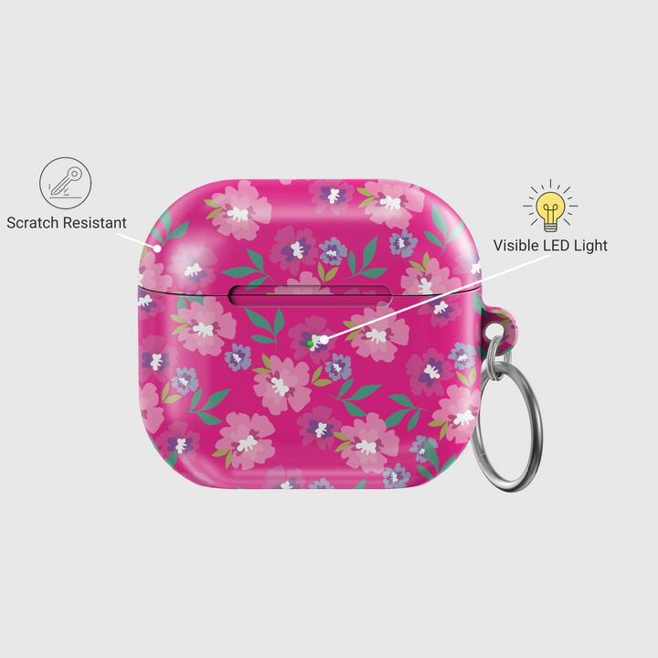 Glossy hot pink AirPods case with colorful floral print featuring white, purple, and pink flowers, includes a silver keychain ring.