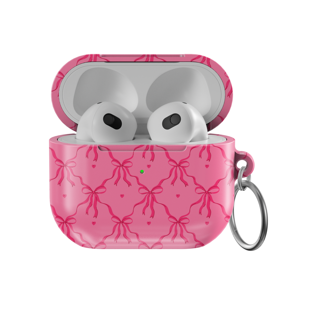 Pink AirPods case cover with bows and hearts design. Compatible with AirPods 3rd Gen. Includes metal keyring for easy carrying. Cute and feminine aesthetic.