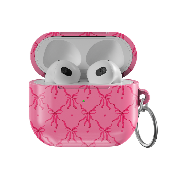 Pink AirPods case cover with bows and hearts design. Compatible with AirPods 3rd Gen. Includes metal keyring for easy carrying. Cute and feminine aesthetic.