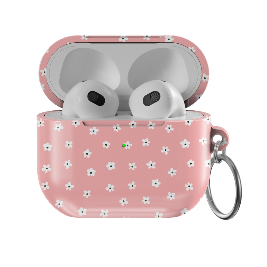 Soft pink AirPods case featuring a pattern of tiny white flowers with a glossy finish and silver keychain, perfect for a girly, floral aesthetic.