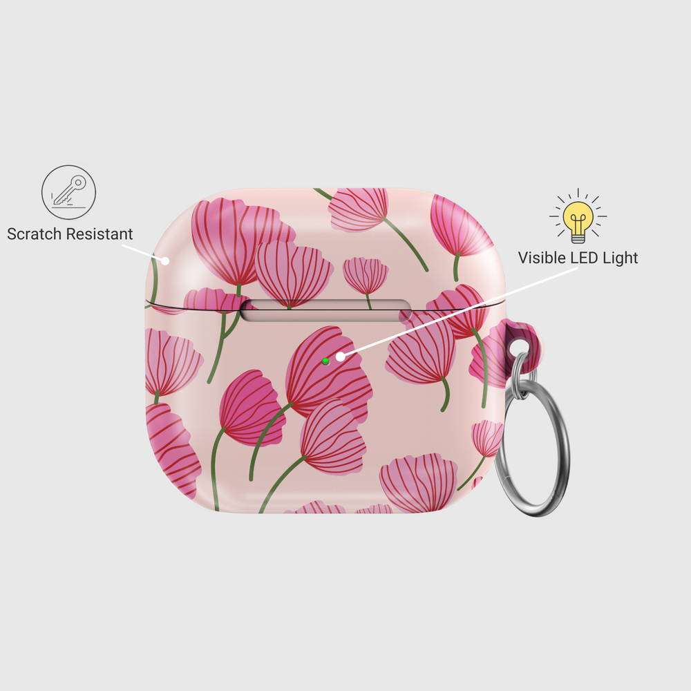 AirPods case with blush pink background featuring stylized red and pink poppy flower design, glossy finish with silver keychain ring.