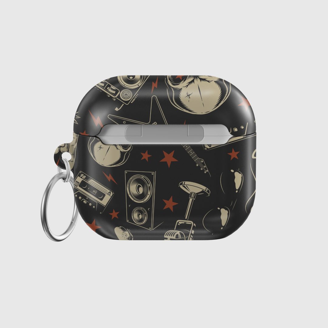 Black AirPods case featuring skull and bones design with retro boombox and red stars, edgy punk rock aesthetic with glossy finish and metal keychain ring.