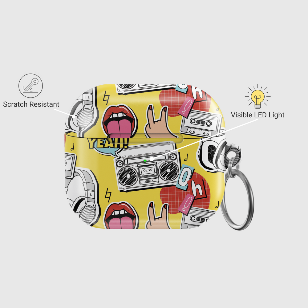 Yellow AirPods case with pop art design featuring boombox, cassette tape, tongue-out lips, headphones, and retro icons in bold cartoon style with a glossy finish and keychain.