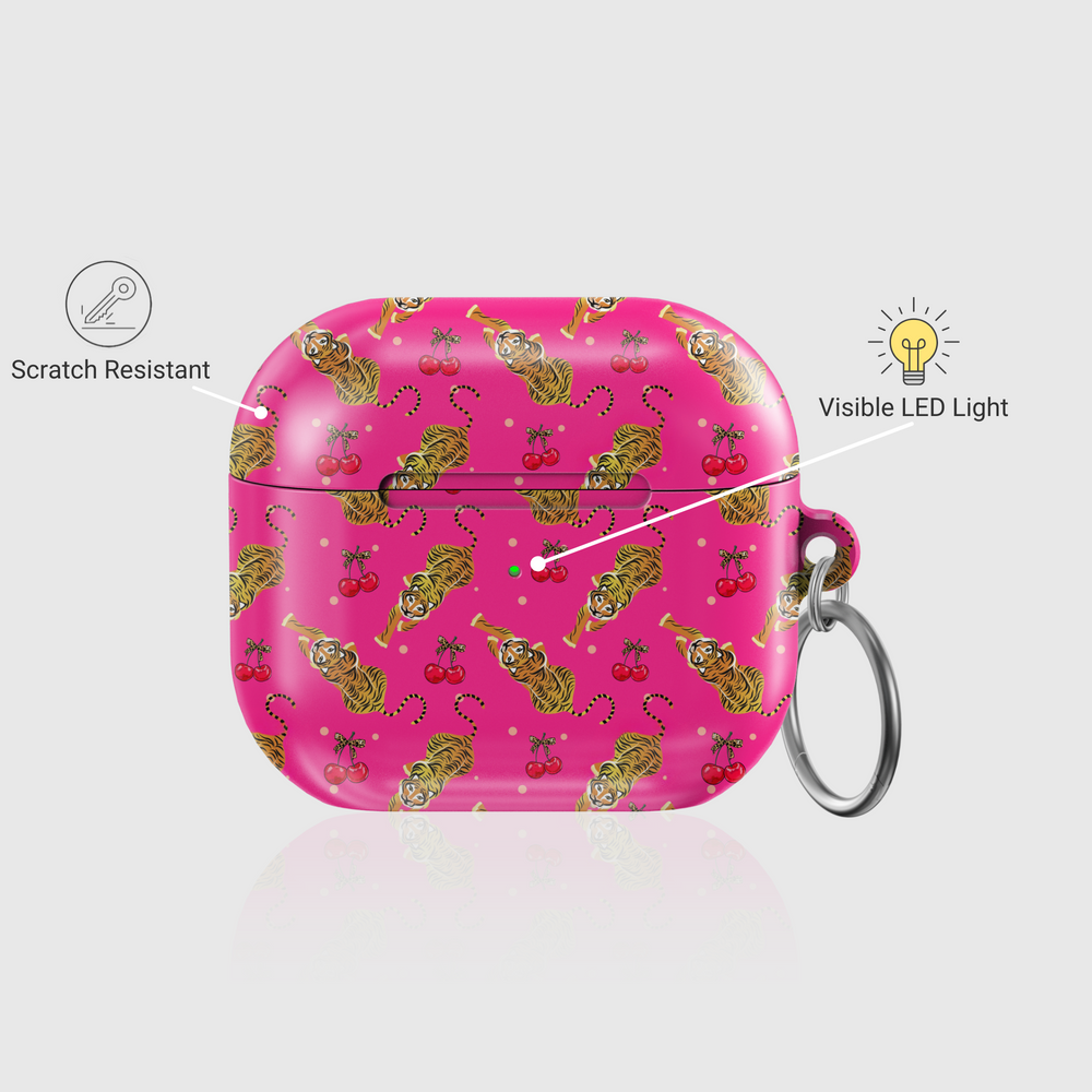 Pink AirPods case cover with playful tiger and cherry pattern, featuring a glossy finish and attached keychain ring. Compatible with AirPods Pro, 3, 2, and 1.