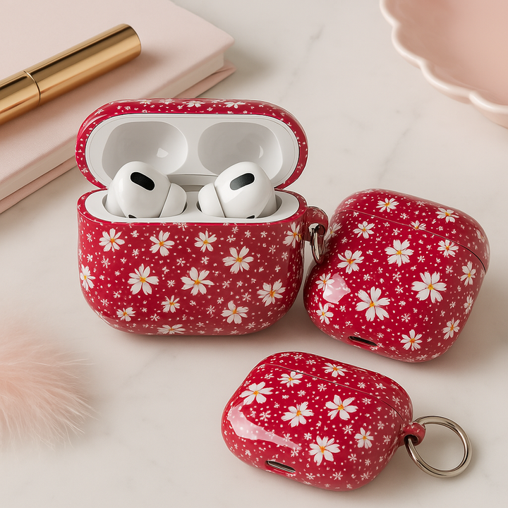 Red AirPods case with white daisy flower pattern and silver keyring, cute floral protective cover for AirPods Pro, retro spring-style accessory.