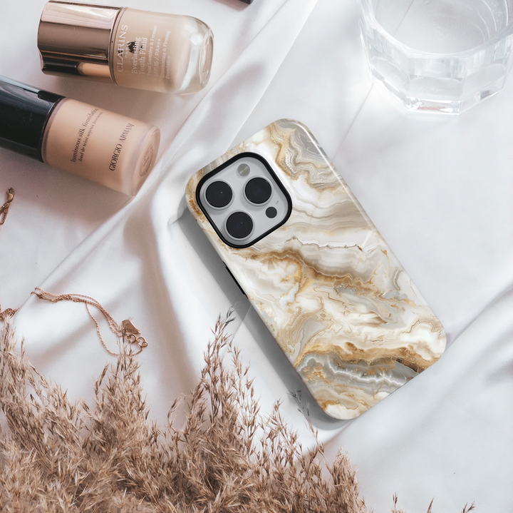 Elegant white marble iPhone case with gold vein accents – luxury stone design cover compatible with iPhone 16, 15, 14 Pro & Plus with MagSafe support.