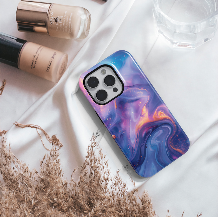 Abstract galaxy swirl iPhone 16 MagSafe case in dreamy purple, blue, and gold tones – aesthetic, protective, and perfect for a cosmic look.