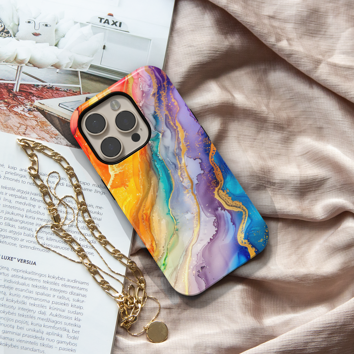 Colorful rainbow marble swirl iPhone 16 MagSafe case with fluid abstract art in yellow, orange, blue, green, and purple hues with gold accents.