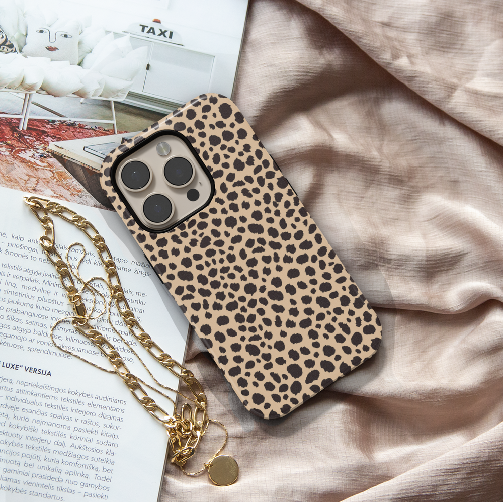 Leopard print iPhone case with bold black animal spots on a tan background, designed for iPhone 16 series with MagSafe compatibility.