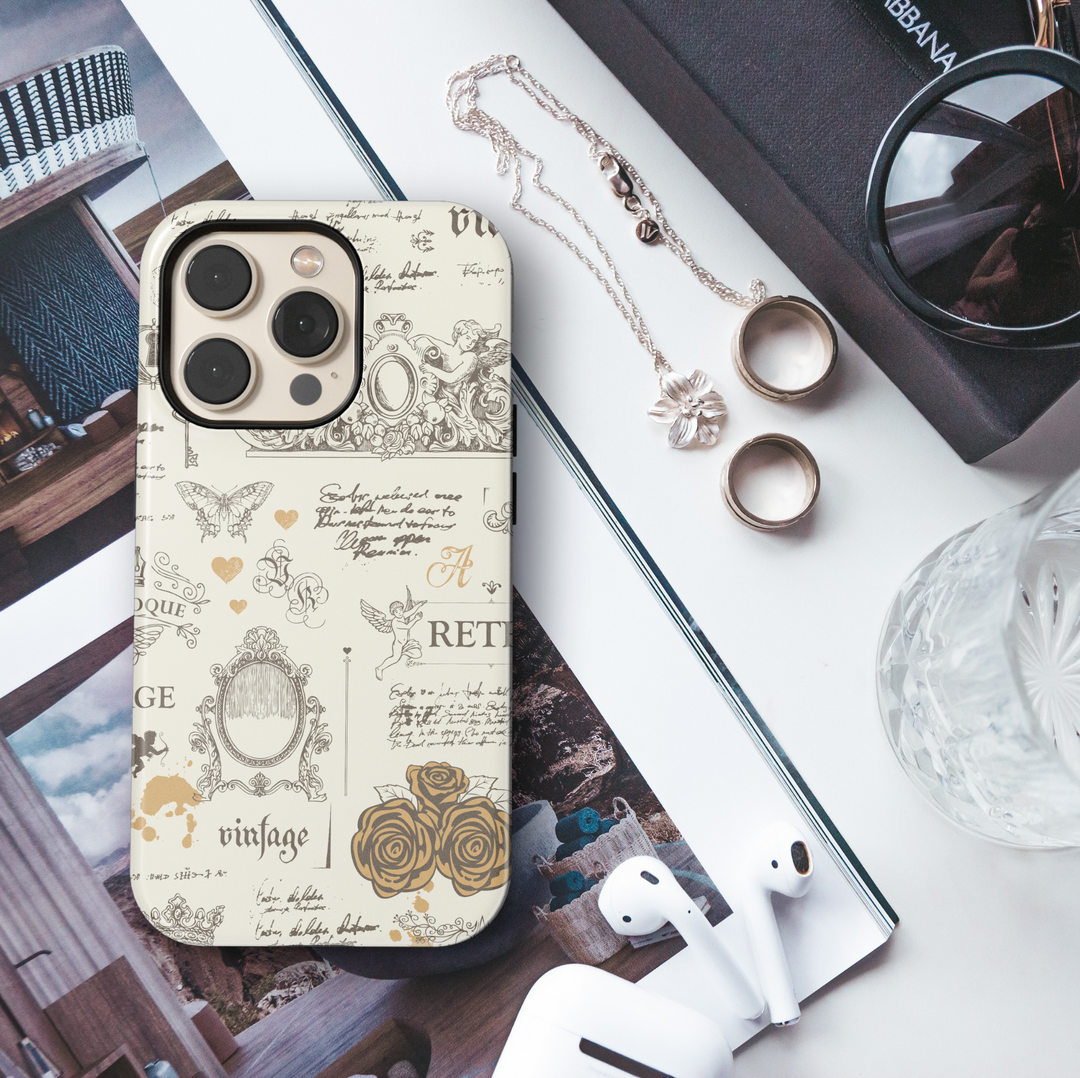 Cream vintage aesthetic iPhone case with antique sketches of cherubs, roses, ornate frames, French script, butterflies, and baroque elements.