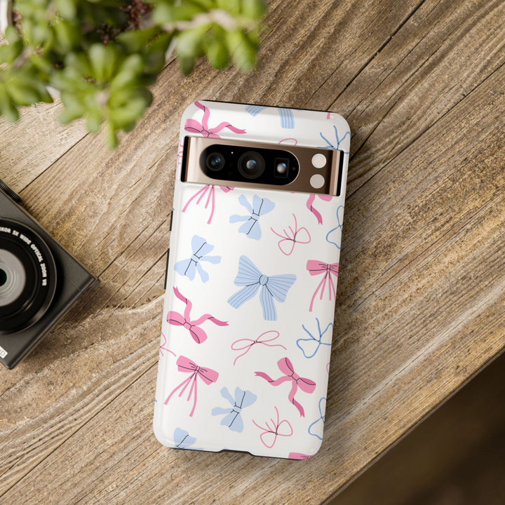 Google Pixel case with pastel pink and blue bows on a white background, coquette aesthetic