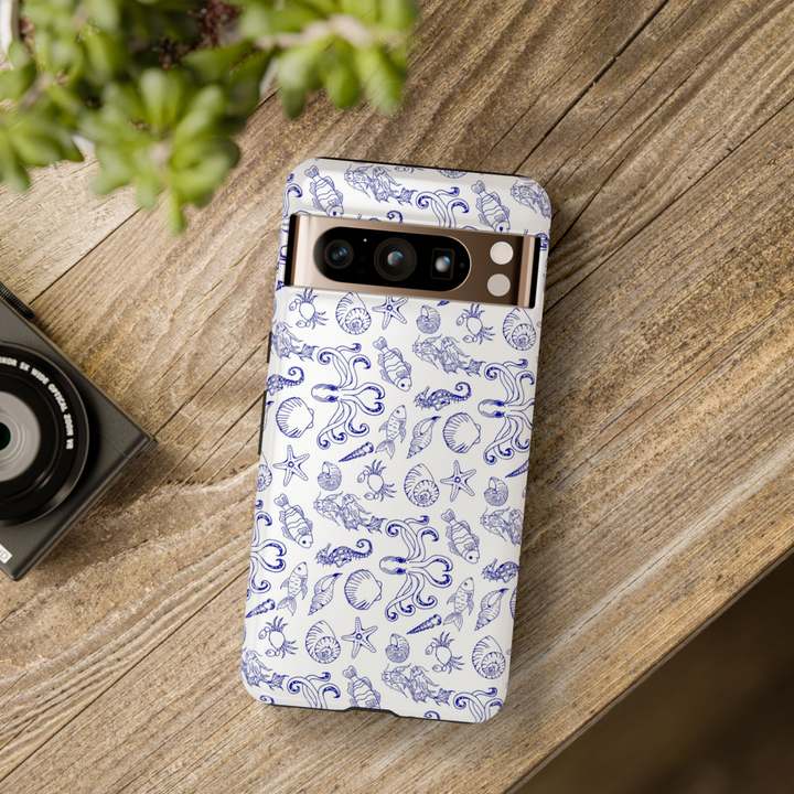 White Google Pixel case with hand-drawn navy blue ocean illustrations of seashells, octopus, fish, coral, and sea life pattern