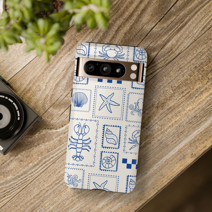 Google Pixel case with navy blue nautical stamp sea creature illustrations on cream background – minimal beach design