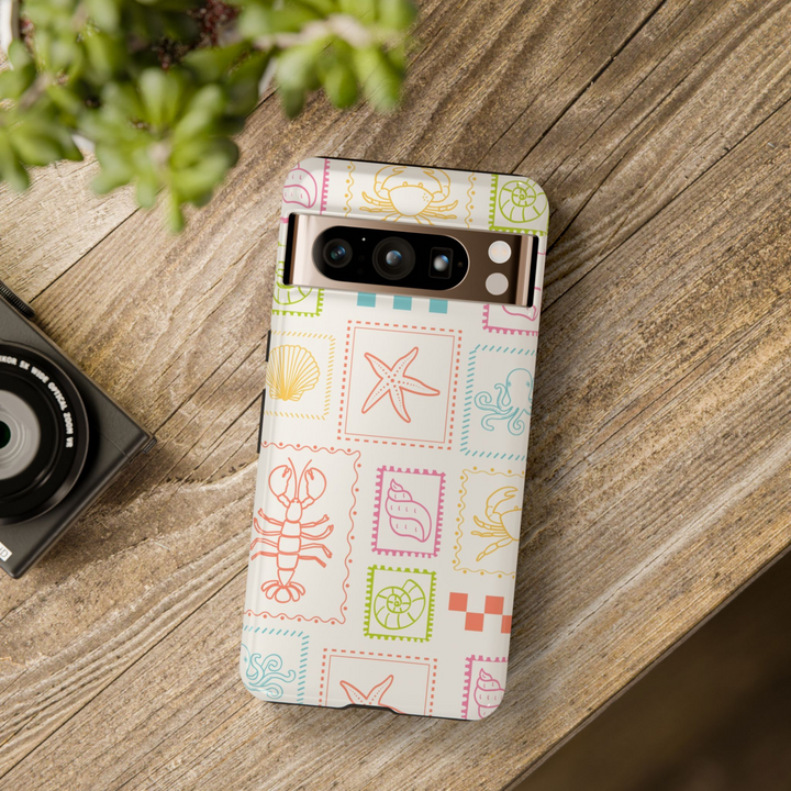 Google Pixel case with colorful stamp-style sea creatures and shells on a cream background – coastal summer design