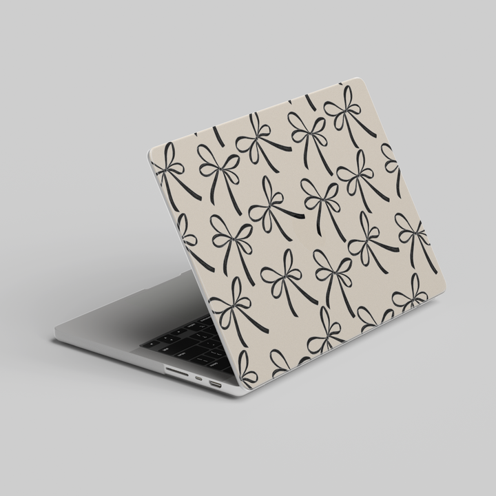 Beige MacBook case with black ribbon bow pattern, elegant minimal aesthetic laptop cover for MacBook Pro and MacBook Air models