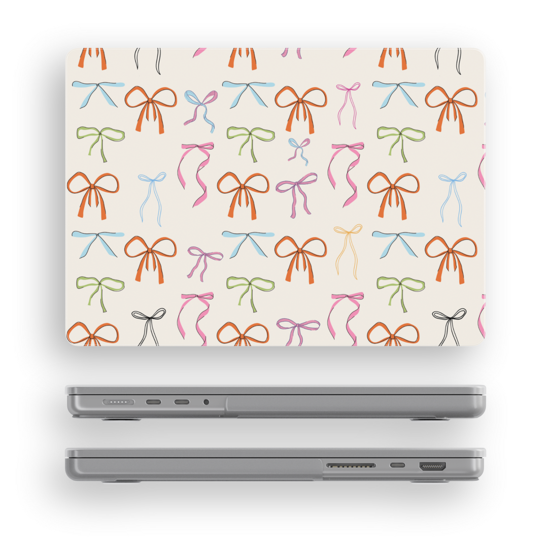 Playful MacBook case with colorful hand-drawn ribbon bows on a cream background, perfect for students, creatives, and aesthetic laptop setups.